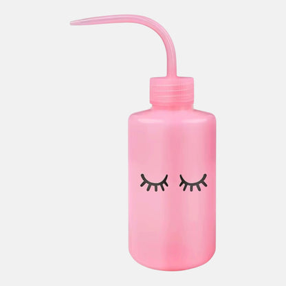 Pink squeeze bottle with eyelash logo for eyelash extensions with precision nozzle and eyelash design, ideal for lash cleanser, saline, and rinsing solutions
