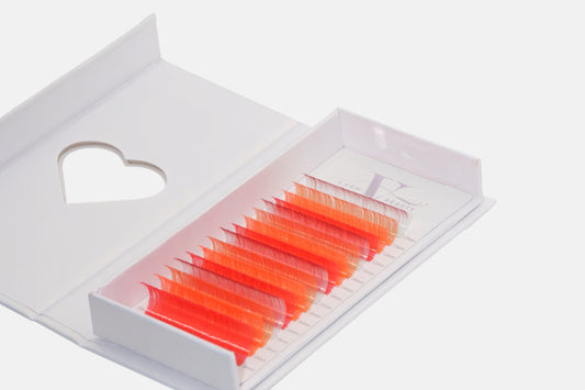 Sunset Glow 0.05mm Colored Lash Extensions featuring coral, neon orange, and hot pink lashes for volume, hybrid, and creative lash designs.
